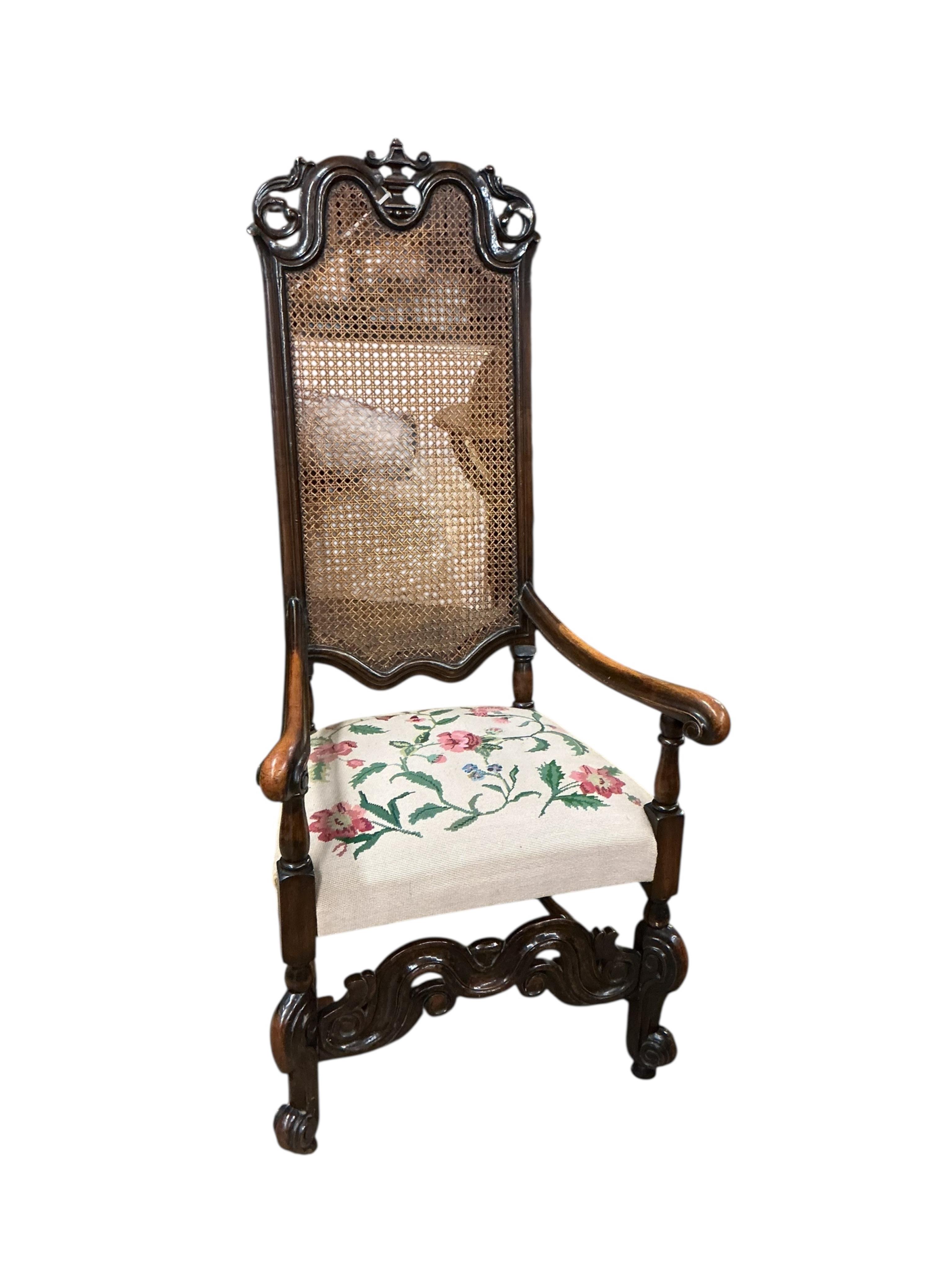 A Carolean style caned walnut high back elbow chair, width 65cm, depth 58cm, height 140cm